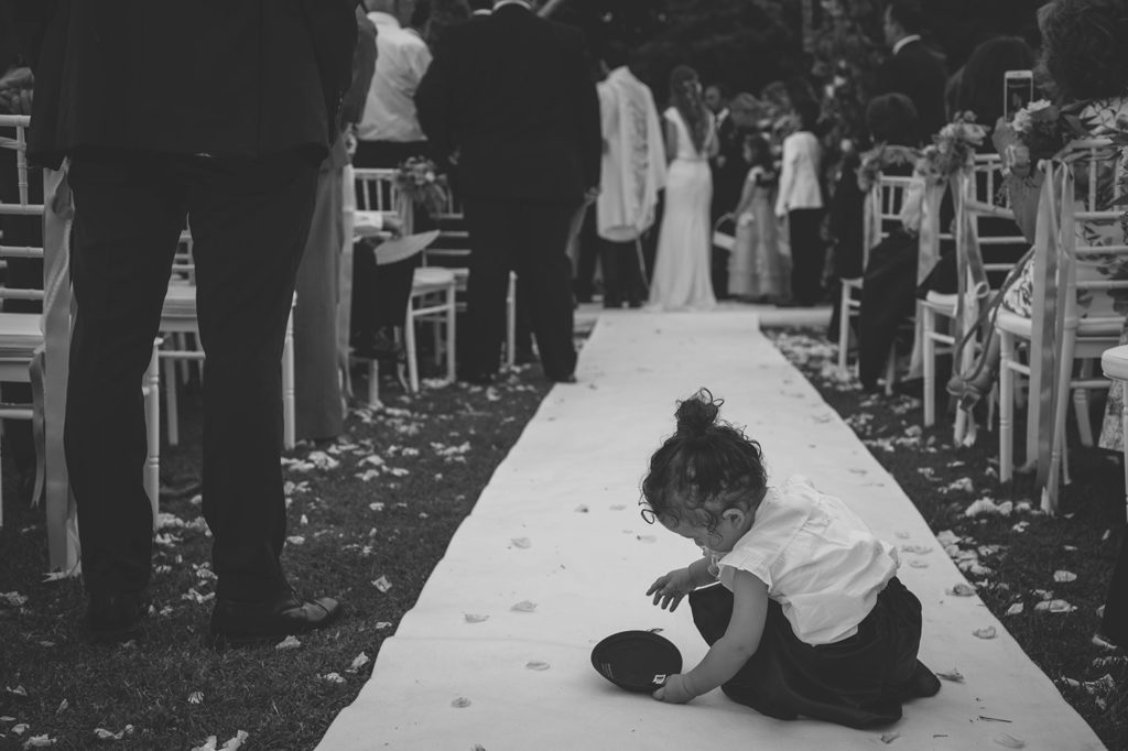 Wedding Photography - Kid playing with a kippah during a Jewish ceremony
