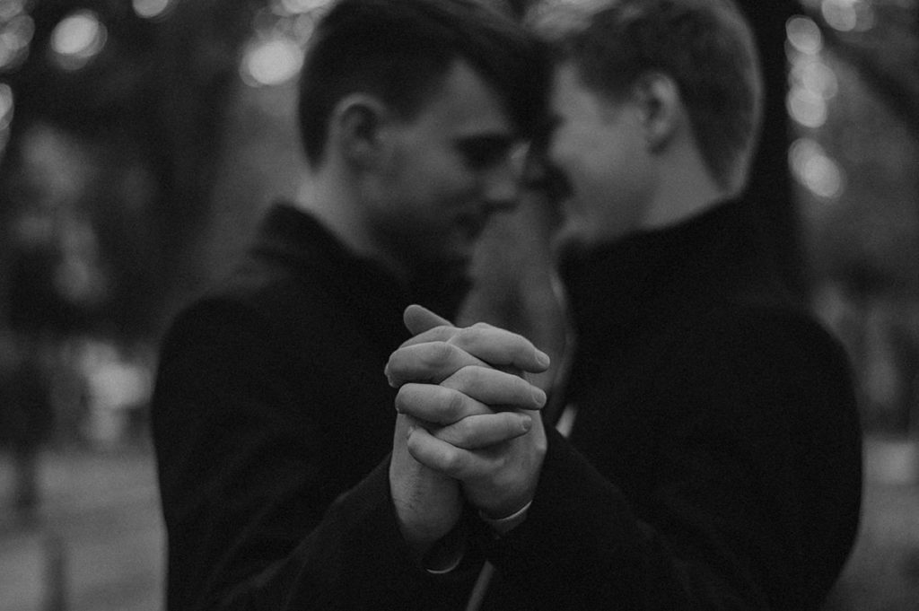 detail: gay couple dancing, interlaced hands