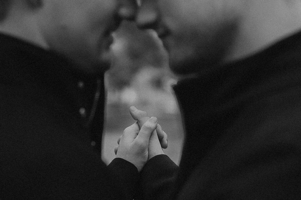detail: gay couple dancing, interlaced hands