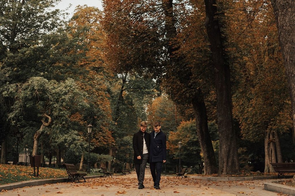 Gay couple walking in a park